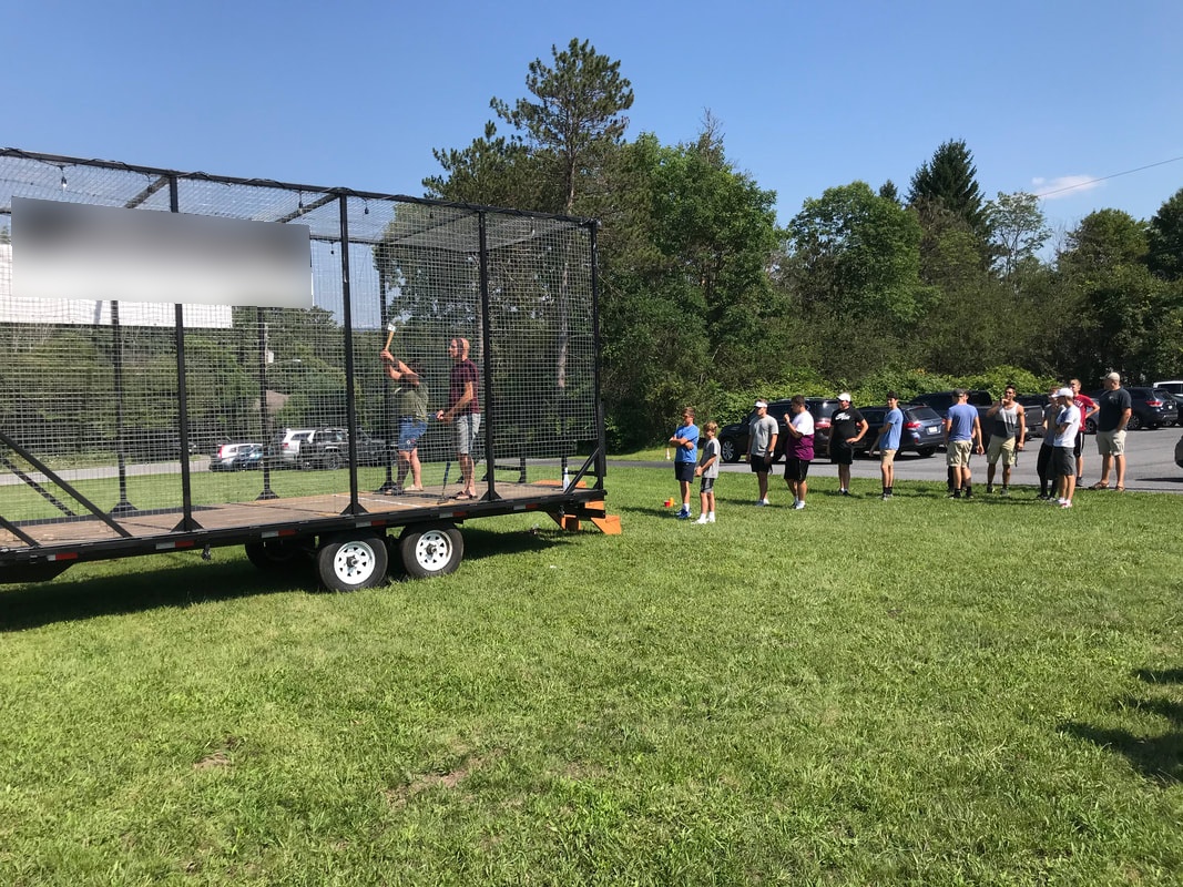 Guests lined up at the Steel City axe throwing trailer at an outdoor event